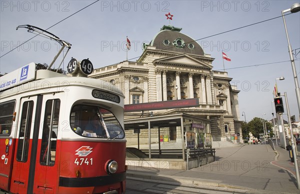 Vienna, Austria. Neubau District. Early model Wiener Linien Tram outside The Volkstheater with digital ticker sign displaying information above entrance to metro station. Austria Austrian Republic Vienna Viennese Wien Europe European City Capital Neubau District Volkstheater Transport Wiener Linien Tram Sign Signs Ticker Digital Architecture Exterior Facade Red Color Destination Destinations Osterreich Signs Display Posted Signage Viena Western Europe