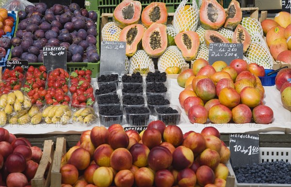 Vienna, Austria. Display of fresh fruit for sale on market stall including plums strawberries papaya mango and nectarines. Austria Austrian Republic Vienna Viennese Wien Europe European City Capital Naschmarkt Market Display Fresh Food Fruit Stall Shop Store Destination Destinations Osterreich Viena Western Europe