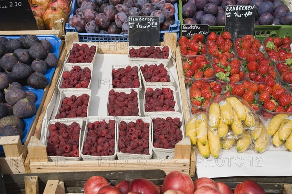 Vienna, Austria. Display of fresh fruit for sale on market stall including figs raspberries strawberries plums and bananas. Austria Austrian Republic Vienna Viennese Wien Europe European City Capital Naschmarkt Market Display Fresh Food Fruit Stall Shop Store Color Destination Destinations Osterreich Viena Western Europe