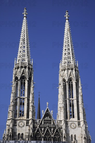 Vienna, Austria. Alsergrund Ringstrasse Votifkirche neo-gothic Votive Church exterior with twin spires. Austria Austrian Vienna Wien Viennese Republic Austro-Bavarian Wean Europe European City Capital Travel Destination Alsergrund Ringstrasse Votifkirche Votive Church Architecture Belltowers Religion Religious Blue Sky Destination Destinations Osterreich Viena Western Europe