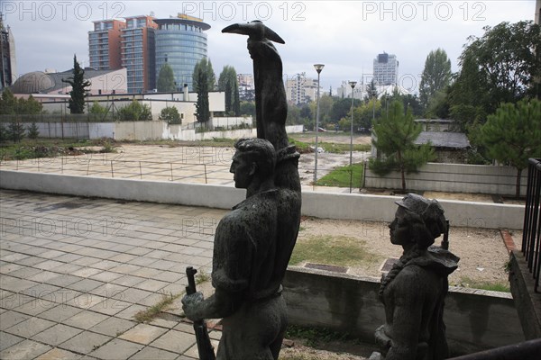 Tirana, Albania. Statue of communist worker holding pickaxe. Albanian Shqip‘ria Southern Europe Albania Albanian Republic Europe European Travel Destination Indo European Tirana Tirane Architecture Architecture Revolutionary Male man man Figure Statue Statue Pick Pickaxe Rifle Color Destination Destinations Gray Male Men Guy