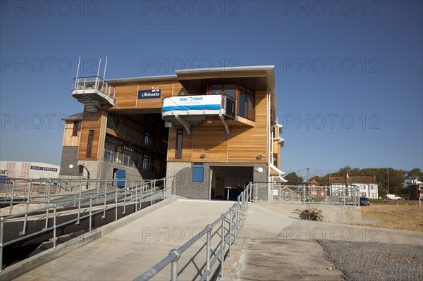 Shoreham-by-Sea, West Sussex, England. Kingston Beach Newly constructed lifeboat house opposite the harbour entrance. England English West Sussex County Shoreham Shoreham-by-Sea by Sea Water Kingston Beach Europe European Architecture Modern Life Boat Lifeboat Lifeboats RNLI Wood Wooden Clad Galvanised Metal Zinc Blue Sky Station Home Timber Frame