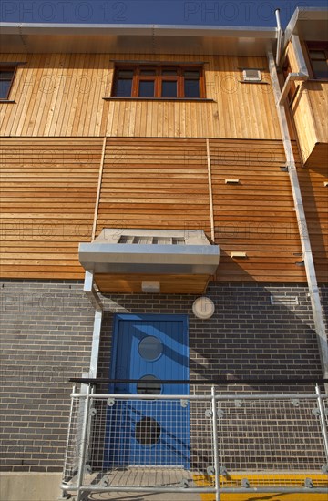 Shoreham-by-Sea, West Sussex, England. Kingston Beach Newly constructed lifeboat house opposite the harbour entrance. England English West Sussex County Shoreham Shoreham-by-Sea by Sea Water Kingston Beach Europe European Architecture Modern Life Boat Lifeboat Lifeboats RNLI Wood Wooden Clad Galvanised Metal Zinc Blue Sky Station Home Timber Frame