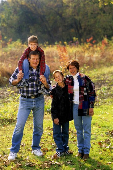 Children with parents in beautiful Fall color setting. Adult Adults Affection Affectionate Arm Around Arms Around Autumn Autumnal Boy Boys Brother Brothers Child Children Color Colour Dad Dads Day Daytime Eye Contact Fall Families Family Father Fathers Field Fields Four People Full Length Group Happiness Happy Kid Kids Looking At Camera Love Loving Man Meadow Meadows Men Mom Moms Mother Mothers Mum Outdoors Outside Paddock Paddocks Parent Parents Pasture Pastures People Person Portrait Portraits Rural Season Seasons Sibling Smile Smiling Son Sons Together Togetherness Woman Women care carefree caring colorful colourful cool share MR Model Released 4 American Contented Female Woman Girl Lady Female Women Girl Lady Forage Pastureland Pasturage Range Field Meadow Grass Graze Grazing Male Man Guy Male Men Guy Northern
