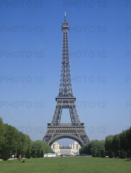 Paris, Ile de France, France. Eiffel Tower from the Parc du Champs de Mars. France French Europe European Ile de France Paris Parisian Eiffel Tower Steel Parc Park Champs de Mars Blue Sky Destination Destinations Western Europe