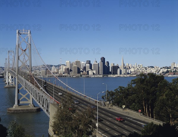 San Francisco, California, USA. Bay Bridge and city skyline beyond. USA United States State America American California San Francisco Bay Bridge City Skyline Cityscape TransAm Trans Transport Sea Water Blue Citiscape Building Buildings Urban Architecture Destination Destinations North America Northern The Golden State United States of America