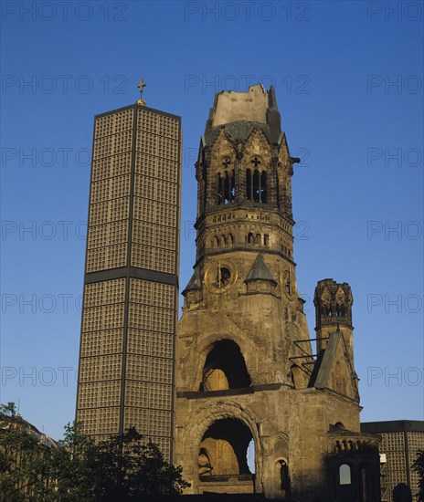 Berlin, Germany. Kurfurstendamn Kaiser Wilhelm memorial church. Germany German Europe European Berlin Ruin Old Modern Architecture New Church Memorial Kaiser Wilhelm Religious Religion Christian Christianity Historic Historial Bombed Kurfurstendamn Blue Sky Destination Destinations Deutschland History Historic Religion Religious Christianity Christians Western Europe