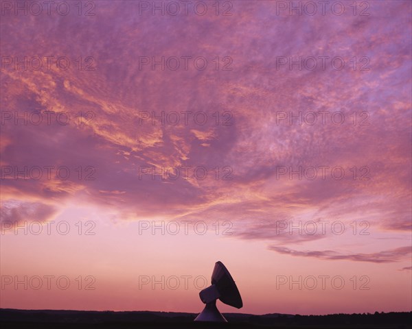 Bavaria, Germany, Communications. Satellite dish against pink and purple sunset sky. Germany German Bavaria Bavarian Satelite Dish Receiver Silhouette Silhouetted Pink Purple Sky Clouds Communications Communication Bayern Blue Clouds Cloud Sky Color Deutschland European Solid Outline Shade Silhouette Solid Outline Shade Silhouetted Sundown Atmospheric Western Europe White