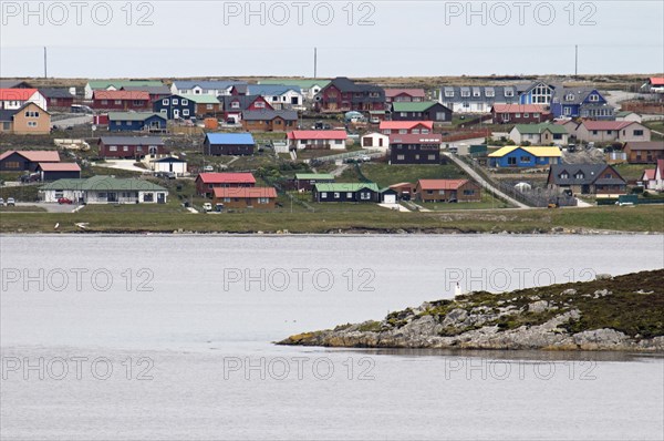 Stanley, Falkland Islands. Residential housing overlooking Stanley Bay red and green roofs single and double-storey units. Falkland Islands Falklands Stanley Architecture House Housing Bay Color colour Colorful Colourful Colored Coloured Mult Water Atlantic Ocean Southern Hemisphere Malvenas One individual Solo Lone Solitary South America