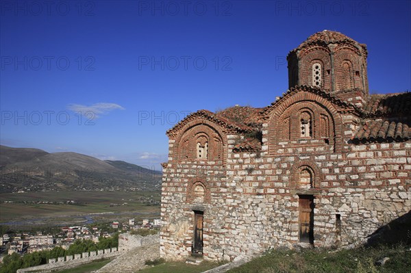 Berat, Albania. St Triada Church on the right with Berat new town beside the River Osum in the background. Albanian Shqip‘ria Southern Europe Albania Albanian Republic Europe European Travel Destination Indo European Berat River Osum Town Church St Saint Triada Church Christian Christianity Byzantine Religion Religious Landscape Floodplain Blue Color Destination Destinations Religion Religious Christianity Christians Scenic