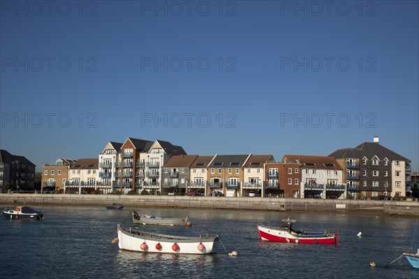 Shoreham-by-Sea, West Sussex, England. Ropetackle riverside housing developement on former industrial site. England English UK United Kingdom GB Great Britain British Europe European West Sussex County Shoreham Shoreham-by-Sea by Sea River Arun Water Waterside Modern Apartment Apartments Flat Flats Architecture Ropetackle Brown Field Development Site Boat Boats Blue Sky