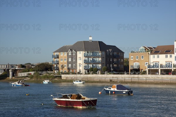 Shoreham-by-Sea, West Sussex, England. Ropetackle riverside housing developement on former industrial site. England English UK United Kingdom GB Great Britain British Europe European West Sussex County Shoreham Shoreham-by-Sea by Sea River Arun Water Waterside Modern Apartment Apartments Flat Flats Architecture Ropetackle Brown Field Development Site Boat Boats Blue Sky