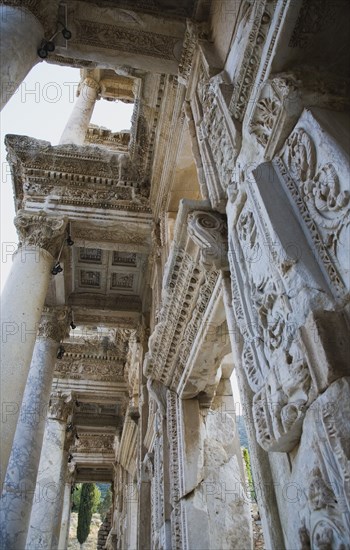 Selcuk, Izmir Province, Turkey. Ephesus. Detail of highly carved walls and ceiling of building in ancient city of Ephesus on the Aegean sea coast. Turkey Turkish Eurasia Eurasian Europe Asia Turkiye Izmir Province Selcuk Ephesus Ruin Ruins Roman Column Columns Facde Ancient Architecture Masonry Rock Stone Destination Destinations European History Historic Middle East South Eastern Europe Water Western Asia