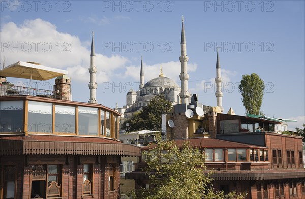 Istanbul, Turkey. Sultanahmet. Rooftop breakfast areas at boutique hotels with view to The Blue Mosque also know as the Sultan Ahmed Mosque. Turkey Turkish Istanbul Constantinople Stamboul Stambul City Europe European Asia Asian East West Urban Destination Travel Tourism Sultanahmet Blue Mosque Hotels Minarets Sultan Ahmed Rooftops Cafe Restaurants Bar Bistro Destination Destinations Middle East Religion Religious South Eastern Europe Turkiye Western Asia