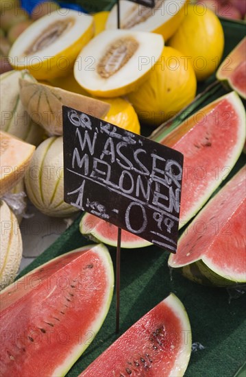 Vienna, Austria. The Naschmarkt. Display of different types of melon for sale on stall with cut slices of watermelon in foreground. Austria Austrian ReAustria Austrian Republic Vienna Viennese Wien Europe European City Capital Naschmarkt Market Display Fresh Food Fruit Vegetables Veg Vegetable Stall Shop Store Color Destination Destinations Osterreich Viena Western Europe