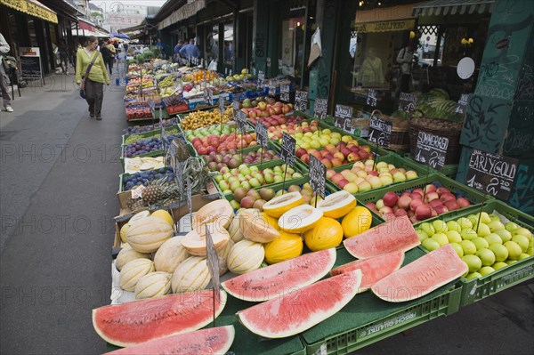 Vienna, Austria. The Naschmarkt. Display of fresh fruit for sale on stall outside shopfront including apples melon and pineapple. Austria Austrian Republic Vienna Viennese Wien Europe European City Capital Naschmarkt Market Display Fresh Food Fruit Vegetables Veg Vegetable Stall Shop Store Destination Destinations Osterreich Viena Western Europe