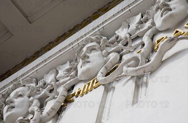 Vienna, Austria. Secession Building. Detail of exterior facade designed by architect Joseph Maria Olbrich in 1897 depicting the heads of three gorgons representing architecture sculpture and painting. Austria Austrian Republic Vienna Viennese Wien Europe European City Capital Architecture Building Exterior Facade Art Gorgons 3 Destination Destinations Osterreich Viena Western Europe