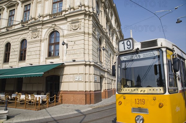 Budapest, Pest County, Hungary. Tram on bank of the River Danube Buda at approach to Chain Bridge. Hungary Hungarian Europe European East Eastern Buda Pest Budapest City Transport Tram Electric Electric Yellow Street Color Destination Destinations Eastern Europe