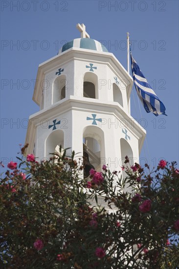 Samos Island, Northern Aegean, Greece. Vathy. White and turquoise Greek Orthodox Church bell tower with domed roof and with Greek flag flying at side. Greece Greek Europe European Vacation Holiday Holidays Travel Destination Tourism Ellas Hellenic Northern Agean Samos Island Vathy Architecture Religion Religious Orthodox Christian Christianity Church Belltower Bell Tower White Flag Blue Sky Cross Crosses Crucifix Color Destination Destinations Ellada Religion Religious Christianity Christians Southern Europe