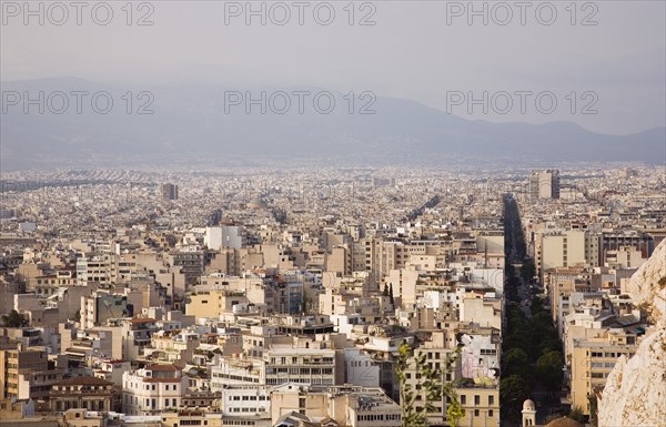 Athens, Attica, Greece. View across city from the Acropolis to Mount Parnitha to the north. Greece Greek Europe European Vacation Holiday Holidays Travel Destination Tourism Ellas Hellenic Attica Athens Acropolis Mount Parnitha Aerial Elevated View City Architecture Rooftops Housing Streets Cityscape Atenas Athenes Destination Destinations Ellada Northern Southern Europe