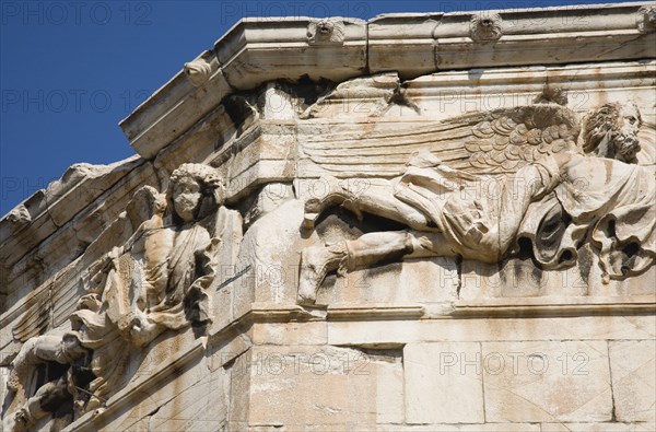 Athens, Attica, Greece. Tower of the Winds. Part view of octagonal Pentelic marble Roman clocktower on the Agora with detail of carved frieze depicting the gods of the winds. Greece Greek Attica Athens Europe European Vacation Holiday Holidays Travel Destination Tourism Ellas Hellenic Agora Pentelic Roman Marble Stone Clocktower Architecture Frieze Atenas Athenes Destination Destinations Ellada History Historic Southern Europe