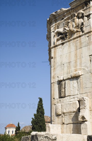 Athens, Attica, Greece. Tower of the Winds on the Agora in Athens. Part view of octagonal Pentelic marble clocktower with detail of carved frieze depicting the gods of the winds. Greece Greek Attica Athens Europe European Vacation Holiday Holidays Travel Destination Tourism Ellas Hellenic Agora Pentelic Roman Marble Stone Clocktower Architecture Frieze Atenas Athenes Blue Destination Destinations Ellada History Historic Southern Europe