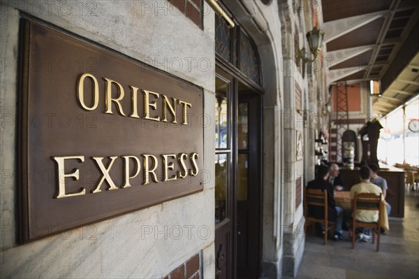 Istanbul, Turkey. Sultanahmet. Orient Express sign beside cafe on station platform. Istanbul Sirkeci Terminal or Sirkeci is a terminus main station of the Turkish State Railways or TCDD in Sirkeci on the European part of Istanbul. International domestic and regional trains running westwards depart from this station which was inaugurated as the terminus of the Orient Express. Turkey Turkish Istanbul Constantinople Stamboul Stambul City Europe European Asia Asian East West Urban Destination Travel Tourism Transportt Rail Railway Train Trains Station Platform Orient Express Orient Express Sirkeci TCCD Bar Bistro Destination Destinations Middle East Restaurant Signs Display Posted Signage South Eastern Europe Turkiye Western Asia