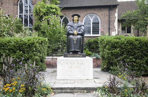 London, England. Cheyne Walk Statue of Thomas Moore by Leslie Cubitt Bevis in front of Chelsea Old Church. England English London Chelsea UK United Kingdom GB Great Britain British Europe European Cheyne Walk Statue Sculpture Art Arts Leslie Cubitt Bevis Thomas Moore Garden Gardens Church Religious Religion Christian Christianity British Isles Color Garden Plants Flora Gardens Plants Great Britain Londres Northern Europe Religion Religious Christianity Christians United Kingdom Colour