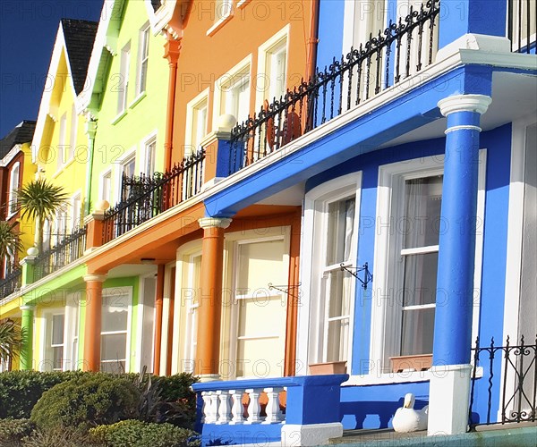 Whitehead, County Antrim, Ireland. Colourfully painted terraced houses with balconies. Ireland Irish Eire Erin Europe European Ulster North County County Antrim Whitehead Color Colorful Colored Colour Colourful Coloured Terrace Terraced House Houses Home Homes Architecture Balcony Balconies Blue orange Yellow Green Destination Destinations Northern Northern Europe Poblacht na hEireann Republic