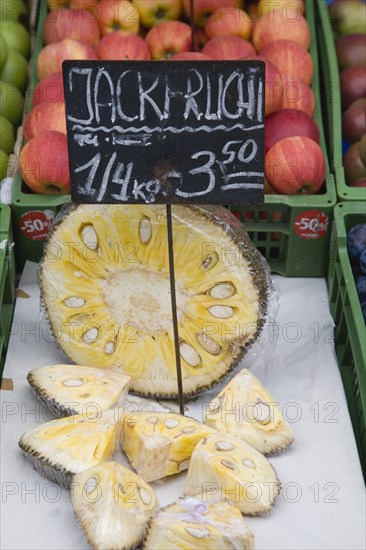 Vienna, Austria. The Naschmarkt. Jack Fruit for sale on fruit stall cut in half and into wedges. Austria Austrian Republic Vienna Viennese Wien Europe European City Capital Naschmarkt Market Display Fresh Food Fruit Vegetables Veg Vegetable Stall Shop Store Destination Destinations Osterreich Viena Western Europe