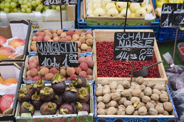 Vienna, Austria. The Naschmarkt. Display of fresh fruit and nuts for sale on market stall including lychees mangosteens and walnuts. Austria Austrian Republic Vienna Viennese Wien Europe European City Capital Naschmarkt Market Display Fresh Food Fruit Vegetables Veg Vegetable Stall Shop Store Destination Destinations Osterreich Viena Western Europe