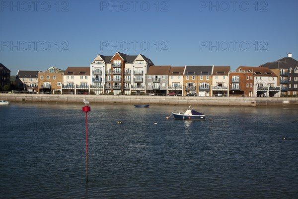 Shoreham-by-Sea, West Sussex, England. Ropetackle riverside housing developement on former industrial site. England English UK United Kingdom GB Great Britain British Europe European West Sussex County Shoreham Shoreham-by-Sea by Sea River Arun Water Waterside Modern Apartment Apartments Flat Flats Architecture Ropetackle Brown Field Development Site Boat Boats Blue Sky