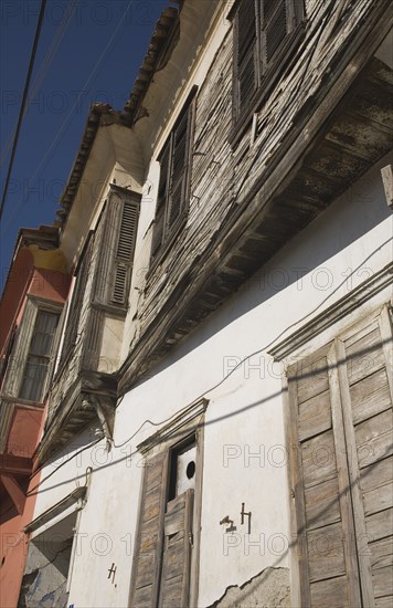 Kusadasi, Aydin Province, Turkey. Exterior facades of Ottoman era whitewashed plaster and wooden houses in the old town. Turkey Turkish Eurasia Eurasian Europe Asia Turkiye Aydin Province Kusadasi Architecture Destination Destinations European Middle East South Eastern Europe Western Asia