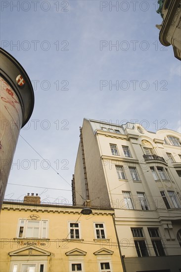 Vienna, Austria. Building exterior facades with partly seen advertising column in foreground. Austria Austrian Republic Vienna Viennese Wien Europe European City Capital Architecture Buildings Exterior Facade Oblique View Destination Destinations Osterreich Viena Western Europe