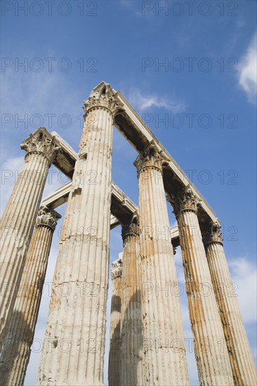 Athens, Attica, Greece. The Temple of Olympian Zeus corinthian capitals and architraves of ruined temple dedicated to king of the Olympian gods Zeus. Greece Greek Attica Athens Europe European Vacation Holiday Holidays Travel Destination Tourism Ellas Hellenic Acropolis Parthenon Temple Olympian Zeus Ruin Ruins Column Columns Atenas Athenes Blue Clouds Cloud Sky Destination Destinations Ellada History Historic Southern Europe