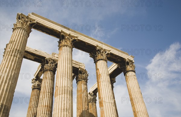 Athens, Attica, Greece. The Temple of Olympian Zeus corinthian capitals and architraves of ruined temple dedicated to king of the Olympian gods Zeus. Greece Greek Attica Athens Europe European Vacation Holiday Holidays Travel Destination Tourism Ellas Hellenic Acropolis Parthenon Temple Olympian Zeus Ruin Ruins Column Columns Atenas Athenes Blue Clouds Cloud Sky Destination Destinations Ellada History Historic Southern Europe