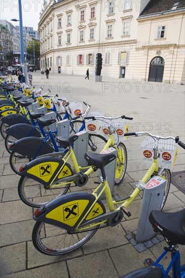 Vienna, Austria. Neubau District. Line of city bicycles for public use at the MuseumsQuartier or Museum Quarter the former Imperial Stalls which were converted into a museum complex in the 1990s housing the Museum of Modern Art or MUMOK the Leopold Museum the Museum of Architecture or Az W and contemporary exhibition spaces. Austria Austrian Republic Vienna Viennese Wien Europe European City Capital Neubau District Museumsquartier Museum Quarter Imperial Mumok Mumok Modern Art Leopold Transport Bicycle Bike Pay Rent Stand Station Tourist Hire Destination Destinations Osterreich Sightseeing Tourists Viena Western Europe