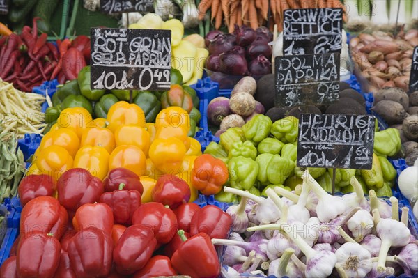 Vienna, Austria. The Naschmarkt. Fresh produce stall with display including chillies peppers garlic onions shallots and turnips. Austria Austrian Republic Vienna Viennese Wien Europe European City Capital Naschmarkt Market Display Fresh Food Fruit Vegetables Veg Vegetable Stall Shop Store Destination Destinations Osterreich Viena Western Europe