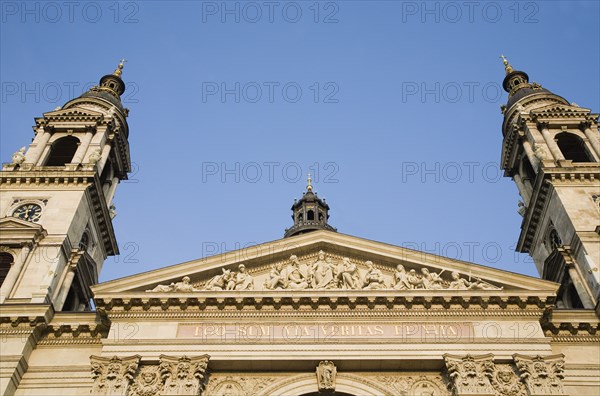 Budapest, Pest County, Hungary. Part view of Saint Stephens Basilica exterior facade. Hungary Hungarian Europe European East Eastern Buda Pest Budapest City Religion Religious Christian Architecture Facade St Saint Stephen Stephens Basilica Blue Sky Destination Destinations Eastern Europe Religion Religious Christianity Christians