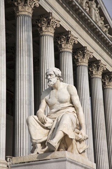 Vienna, Austria. Statue of the Greek philosopher Thucydides in front of the columns to the Parliament Building. Austria Austrian Vienna Wien Viennese Republic Austro-Bavarian Wean Europe European City Capital Travel Destination Art Statue Architecture Greek Figure Male Man Philiosopher Thucydides Column Columns Exterior Facade Parliament Architecture Building Destination Destinations History Historic Male Men Guy Osterreich Parliment Viena Western Europe