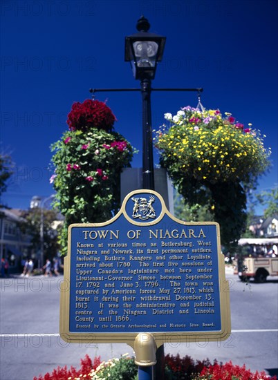 Niagara on the Lake, Ontario, Canada. Queen Street. Plaque and hanging baskets. Blue Canadian Destination Destinations North America