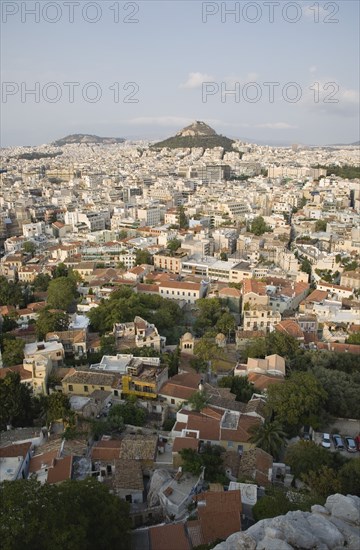 Athens, Attica, Greece. Mount Lycabettus rising in central Athens with densely populated city below. Greece Greek Europe European Vacation Holiday Holidays Travel Destination Tourism Ellas Hellenic Attica Athens City View Aerial Cityscape Elevated Houses Housing Mount Lycabettus Atenas Athenes Destination Destinations Ellada Southern Europe
