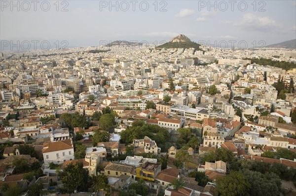 Athens, Attica, Greece. Mount Lycabettus rising in central Athens with densely populated city below. Greece Greek Europe European Vacation Holiday Holidays Travel Destination Tourism Ellas Hellenic Attica Athens City View Cityscape Aerial Elevated Houses Housing Mount Lycabettus Atenas Athenes Destination Destinations Ellada Southern Europe