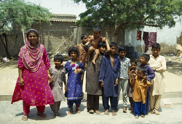 Brahmin Hyden, Sindh Province, Pakistan. Extended family woman with her children neices and nephews. Asia Asian Female Women Girl Lady Immature Kids Old Senior Aged Pakistani