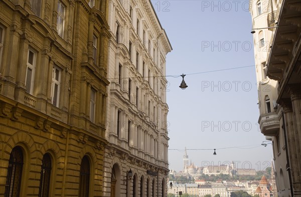 Budapest, Pest County, Hungary. Part view of apartment buildings in Pest on the banks of the River Danube framing view towards river. Hungary Hungarian Europe European East Eastern Buda Pest Budapest City Urban Architecture Apartment Flats Apartments Building Buildings Destination Destinations Eastern Europe Flat