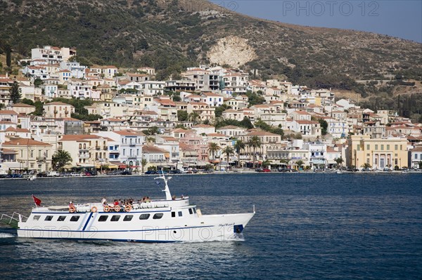 Samos, Northern Aegean, Greece. Vathy. Ferry between Samos and Kusadasi in Turkey as it leaves Vathy. Town houses spread across hillside behind. Greece Greek Europe European Vacation Holiday Holidays Travel Destination Tourism Ellas Hellenic Northern Aegean Samos Island Vathy Transport Ferry Boat Ship Water Sea Hills Harbour Harbor Houses Housing Destination Destinations Ellada Middle East South Eastern Europe Southern Europe Turkish Turkiye Water Western Asia