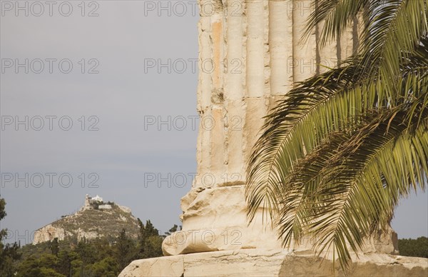 Athens, Attica, Greece. The Temple of Olympian Zeus column base of ruined temple dedicated to king of the Olympian gods Zeus with Mount Lycabettus rising behind. Greece Greek Attica Athens Europe European Vacation Holiday Holidays Travel Destination Tourism Ellas Hellenic Acropolis Parthenon Temple Olympian Zeus Ruin Ruins Column Columns Atenas Athenes Destination Destinations Ellada History Historic Southern Europe