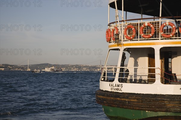 Istanbul, Turkey. Sultanahmet. Ferry flying Turkish flag on the Bosphorous with bridge behind. Since March 2006 Istanbuls traditional commuter ferries have been operated by Istanbul Sea Buses. Turkey Turkish Istanbul Constantinople Stamboul Stambul City Europe European Asia Asian East West Urban Sultanahmet Bosphorous Destination Travel Tourism Transport Water Ship Boat Ferry Commuter Cummuters Classic Classical Destination Destinations Historical Middle East Older South Eastern Europe Turkiye Water Western Asia