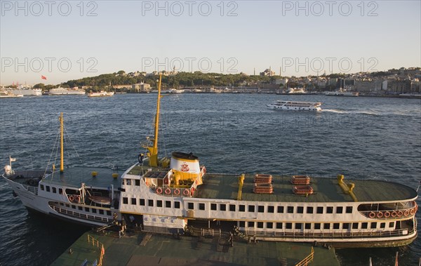 Istanbul, Turkey. Sultanahmet. Bosphorous passenger ferry moored at sunset with the Hagia Sophia behind. Turkey Turkish Istanbul Constantinople Stamboul Stambul City Europe European Asia Asian East West Urban Destination Travel Tourism Sultanahmet Bosphorous Passenger Passengers Ferry Boat Ship Transport Water Sea Commute Commuters Hagia Sophia Mosque Destination Destinations Middle East South Eastern Europe Sundown Atmospheric Turkiye Water Western Asia