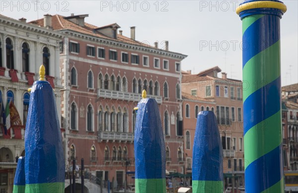 Venice, Veneto, Italy. Green yellow and blue painted poles of gondola station from Rialto bridge looking along the Grand Canal. Italy Italia Italian Venice Veneto Venezia Europe European City Grand Canal Painted Blue Poles Gondola Station Water Color Destination Destinations Southern Europe